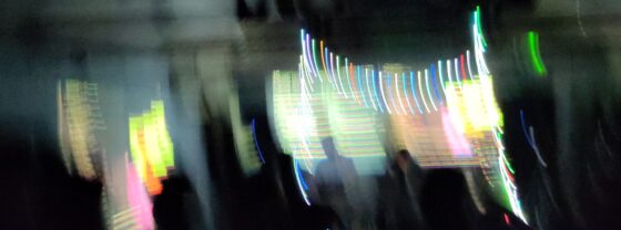 Blurry photograph of some live coders