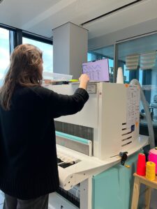 Helen working at the TC/2 loom, which looks a bit like a large photocopier!